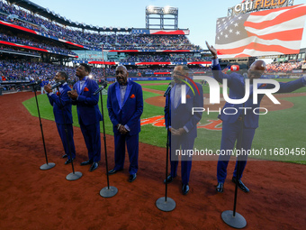 The Temptations sing the National Anthem on the field before Game 5 of a baseball NL Championship Series between the Los Angeles Dodgers and...