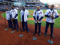 The Temptations sing the National Anthem on the field before Game 5 of a baseball NL Championship Series between the Los Angeles Dodgers and...