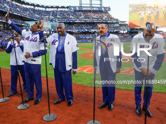 The Temptations sing the National Anthem on the field before Game 5 of a baseball NL Championship Series between the Los Angeles Dodgers and...