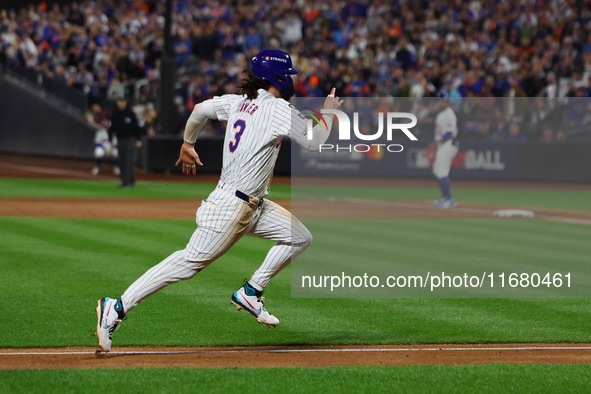 Jesse Winker #3 of the New York Mets scores on a sacrifice fly during the sixth inning in Game 5 of the baseball NL Championship Series agai...