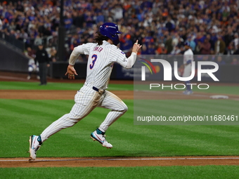 Jesse Winker #3 of the New York Mets scores on a sacrifice fly during the sixth inning in Game 5 of the baseball NL Championship Series agai...