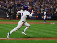 Jesse Winker #3 of the New York Mets scores on a sacrifice fly during the sixth inning in Game 5 of the baseball NL Championship Series agai...