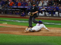 Jesse Winker #3 of the New York Mets scores on a sacrifice fly during the sixth inning in Game 5 of the baseball NL Championship Series agai...