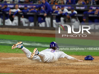 Jesse Winker #3 of the New York Mets scores on a sacrifice fly during the sixth inning in Game 5 of the baseball NL Championship Series agai...