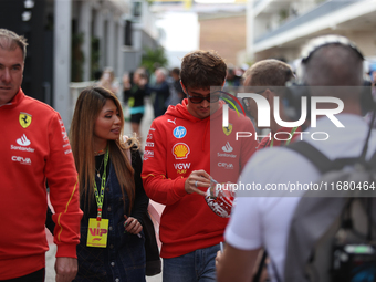 Charles Leclerc signs merchandise for his fans in the paddock at Circuit of the Americas in Austin, Texas, on October 18, 2024, during the F...