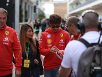 Charles Leclerc signs merchandise for his fans in the paddock at Circuit of the Americas in Austin, Texas, on October 18, 2024, during the F...