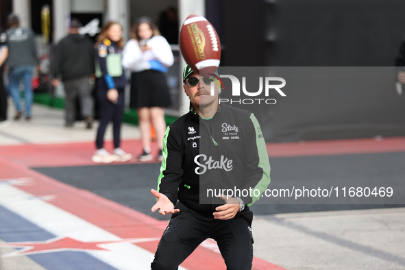 Valtteri Bottas attempts to catch an American football as he walks through the paddock at Circuit of the Americas in Austin, Texas, on Octob...