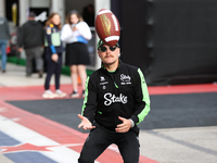 Valtteri Bottas attempts to catch an American football as he walks through the paddock at Circuit of the Americas in Austin, Texas, on Octob...