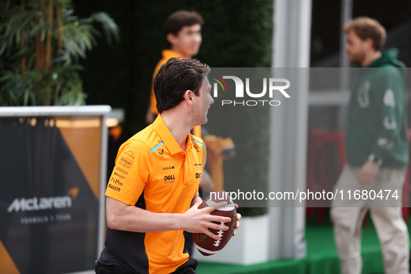 Pato O'Ward catches an American football as he walks through the paddock at Circuit of the Americas in Austin, Texas, on October 18, 2024, d...