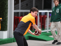 Pato O'Ward catches an American football as he walks through the paddock at Circuit of the Americas in Austin, Texas, on October 18, 2024, d...