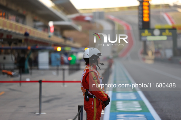 Pit marshals wait in pit lane for an inspection at Circuit of the Americas in Austin, United States, on October 18, 2024, during the Formula...