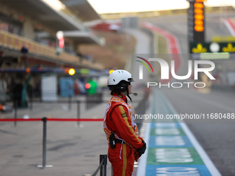 Pit marshals wait in pit lane for an inspection at Circuit of the Americas in Austin, United States, on October 18, 2024, during the Formula...