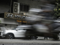 The signage of Hyundai Motor India Ltd. is seen in front of an authorized Hyundai vehicle workshop in Mumbai, India, on October 19, 2024. Th...