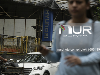 The signage of Hyundai Motor India Ltd. is seen in front of an authorized Hyundai vehicle workshop in Mumbai, India, on October 19, 2024. Th...