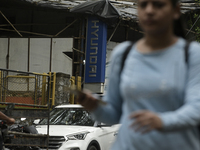 The signage of Hyundai Motor India Ltd. is seen in front of an authorized Hyundai vehicle workshop in Mumbai, India, on October 19, 2024. Th...