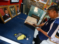 Workers make photo frames of the President-elect of the Republic of Indonesia, Prabowo Subianto, and Vice President Gibran Rakabuming at Rum...