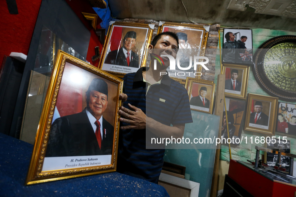 Workers make photo frames of the President-elect of the Republic of Indonesia, Prabowo Subianto, and Vice President Gibran Rakabuming at Rum...