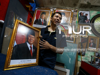 Workers make photo frames of the President-elect of the Republic of Indonesia, Prabowo Subianto, and Vice President Gibran Rakabuming at Rum...