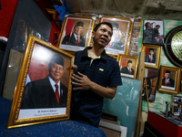 Workers make photo frames of the President-elect of the Republic of Indonesia, Prabowo Subianto, and Vice President Gibran Rakabuming at Rum...