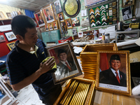 Workers make photo frames of the President-elect of the Republic of Indonesia, Prabowo Subianto, and Vice President Gibran Rakabuming at Rum...