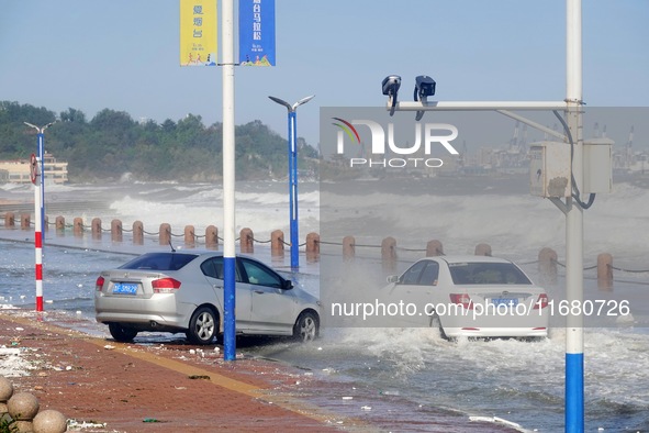 Cars pass a road covered with seawater at the seaside in Yantai, China, on October 19, 2024. 