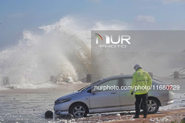 Big waves hit vehicles at the seaside in Yantai, China, on October 19, 2024. 