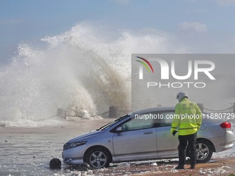 Big waves hit vehicles at the seaside in Yantai, China, on October 19, 2024. (