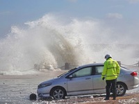 Big waves hit vehicles at the seaside in Yantai, China, on October 19, 2024. (