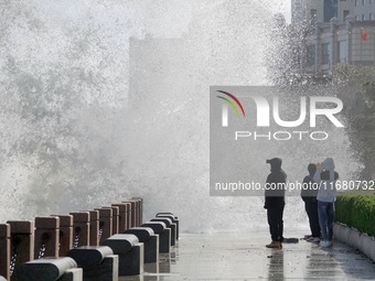 Tourists watch waves at the seaside in Yantai, China, on October 19, 2024. (