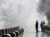 Tourists watch waves at the seaside in Yantai, China, on October 19, 2024. (