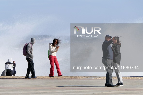 Tourists watch waves at the seaside in Yantai, China, on October 19, 2024. 