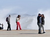 Tourists watch waves at the seaside in Yantai, China, on October 19, 2024. (