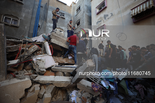 Palestinians inspect the damage to a building following Israeli bombardment in the Maghazi camp for Palestinian refugees in the central Gaza...