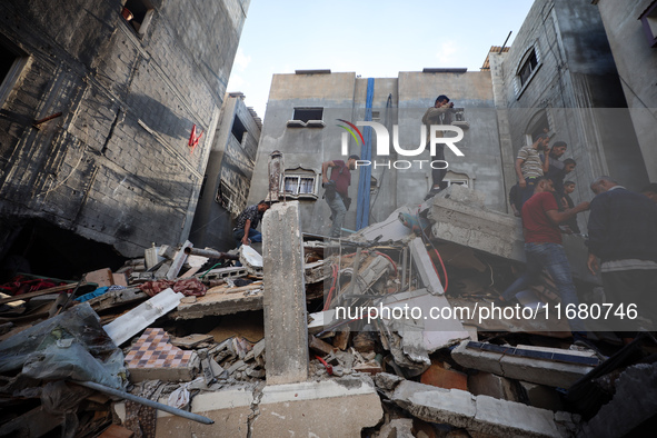 Palestinians inspect the damage to a building following Israeli bombardment in the Maghazi camp for Palestinian refugees in the central Gaza...