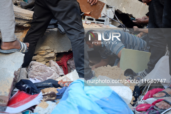 Palestinians inspect the damage to a building following Israeli bombardment in the Maghazi camp for Palestinian refugees in the central Gaza...