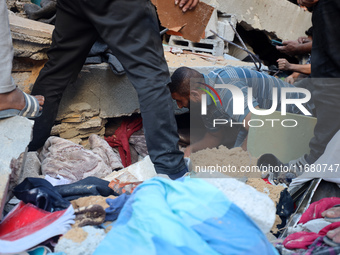 Palestinians inspect the damage to a building following Israeli bombardment in the Maghazi camp for Palestinian refugees in the central Gaza...