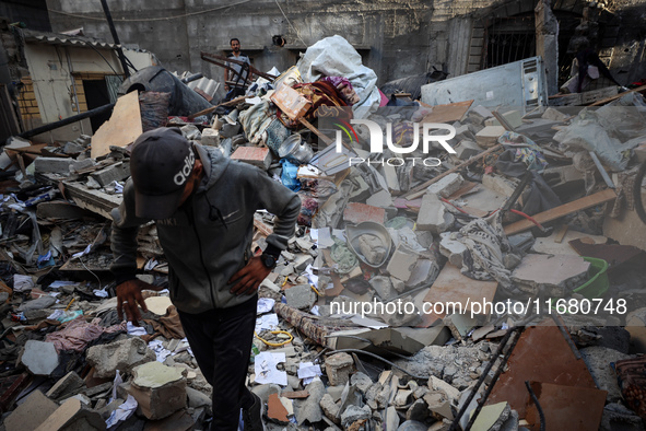 Palestinians inspect the damage to a building following Israeli bombardment in the Maghazi camp for Palestinian refugees in the central Gaza...