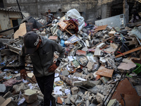 Palestinians inspect the damage to a building following Israeli bombardment in the Maghazi camp for Palestinian refugees in the central Gaza...