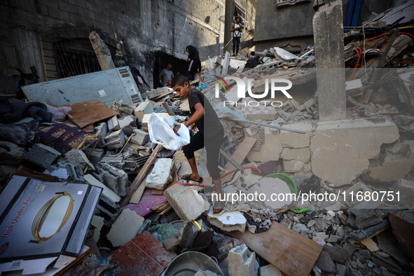 Palestinians inspect the damage to a building following Israeli bombardment in the Maghazi camp for Palestinian refugees in the central Gaza...