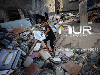 Palestinians inspect the damage to a building following Israeli bombardment in the Maghazi camp for Palestinian refugees in the central Gaza...