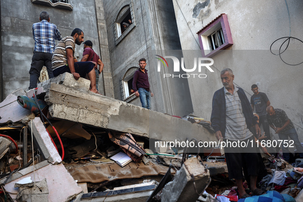 Palestinians inspect the damage to a building following Israeli bombardment in the Maghazi camp for Palestinian refugees in the central Gaza...