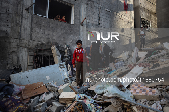 Palestinians inspect the damage to a building following Israeli bombardment in the Maghazi camp for Palestinian refugees in the central Gaza...