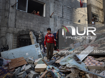 Palestinians inspect the damage to a building following Israeli bombardment in the Maghazi camp for Palestinian refugees in the central Gaza...