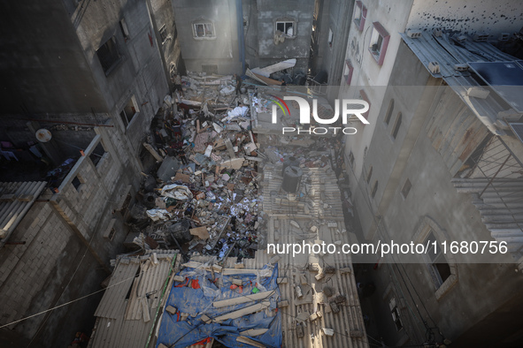 Palestinians inspect the damage to a building following Israeli bombardment in the Maghazi camp for Palestinian refugees in the central Gaza...