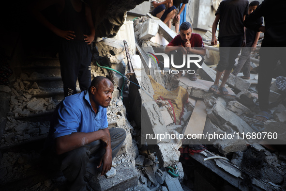 Palestinians inspect the damage to a building following Israeli bombardment in the Maghazi camp for Palestinian refugees in the central Gaza...