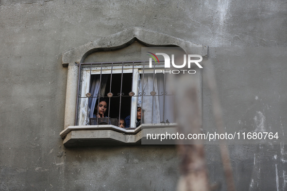 Palestinians inspect the damage to a building following Israeli bombardment in the Maghazi camp for Palestinian refugees in the central Gaza...