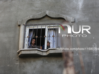 Palestinians inspect the damage to a building following Israeli bombardment in the Maghazi camp for Palestinian refugees in the central Gaza...