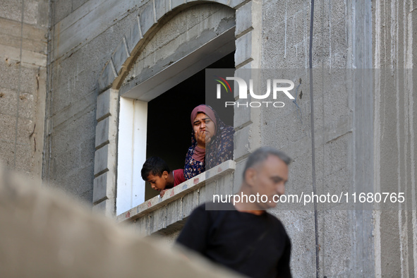 Palestinians inspect the damage to a building following Israeli bombardment in the Maghazi camp for Palestinian refugees in the central Gaza...