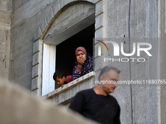 Palestinians inspect the damage to a building following Israeli bombardment in the Maghazi camp for Palestinian refugees in the central Gaza...