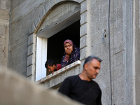 Palestinians inspect the damage to a building following Israeli bombardment in the Maghazi camp for Palestinian refugees in the central Gaza...